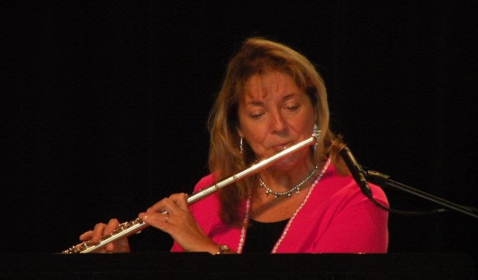 Mollie Magee playing the flute on stage